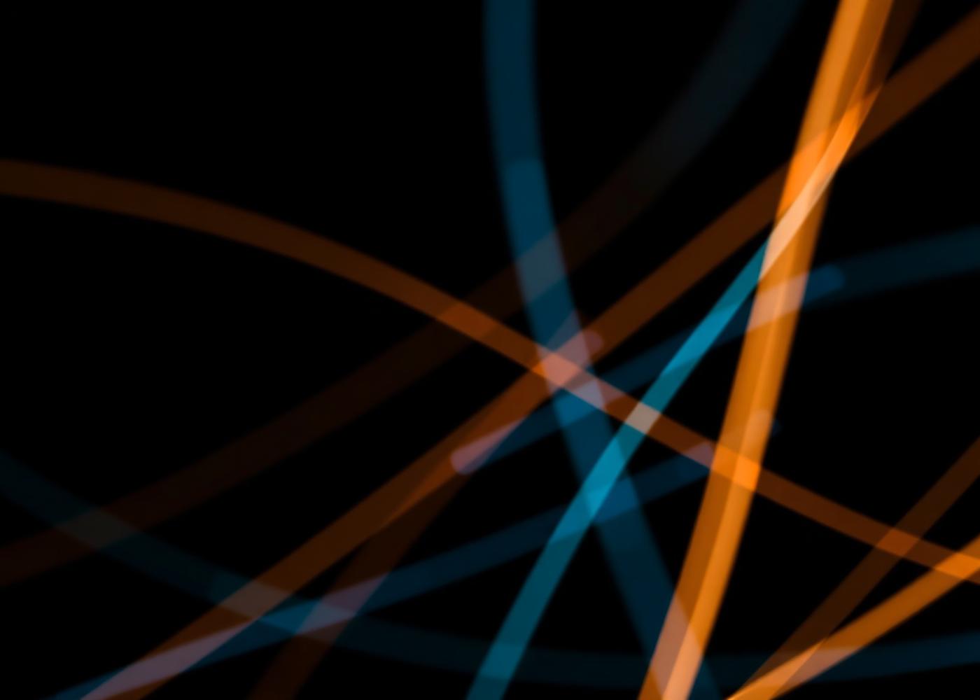 Long-exposure light trails from fibre optic strands crossing on a dark background